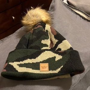 Camo winter hat with fur Pom Pom brand is Towne.